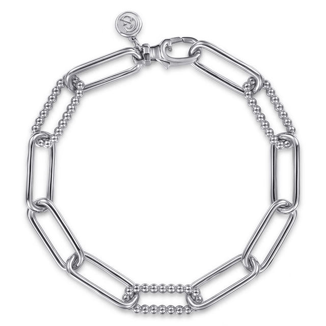 A silver-tone chain link bracelet featuring alternating large paperclip links and smaller beaded links, with a spring-ring clasp and a small circular logo charm.