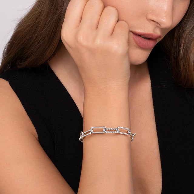 Close-up of a woman's wrist wearing a silver bracelet.