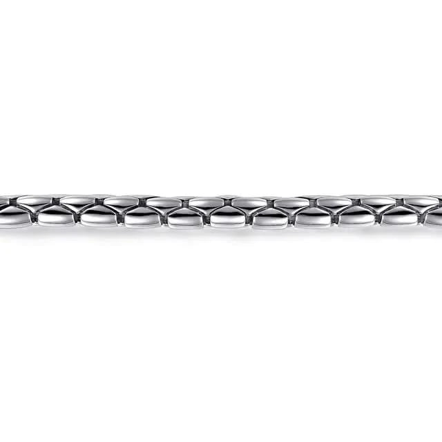 Close-up of a silver chain bracelet on a white background