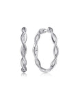 Pair of twisted silver hoop earrings on a white background