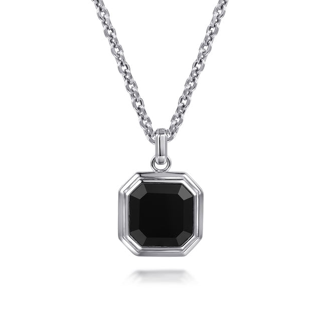 A silver-toned octagonal pendant necklace with a faceted black gemstone, suspended from a matching silver chain on a white background.