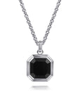 A silver-toned octagonal pendant necklace with a faceted black gemstone, suspended from a matching silver chain on a white background.