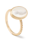 Gold ring with a large white mother of pearl stone on a white background