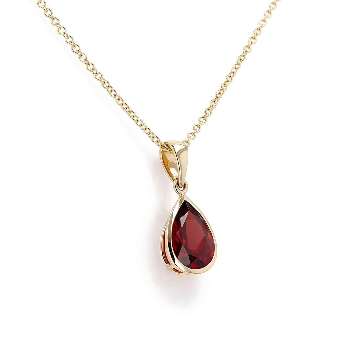 Necklace with a pear shaped garnet pendant bezel set on a white background