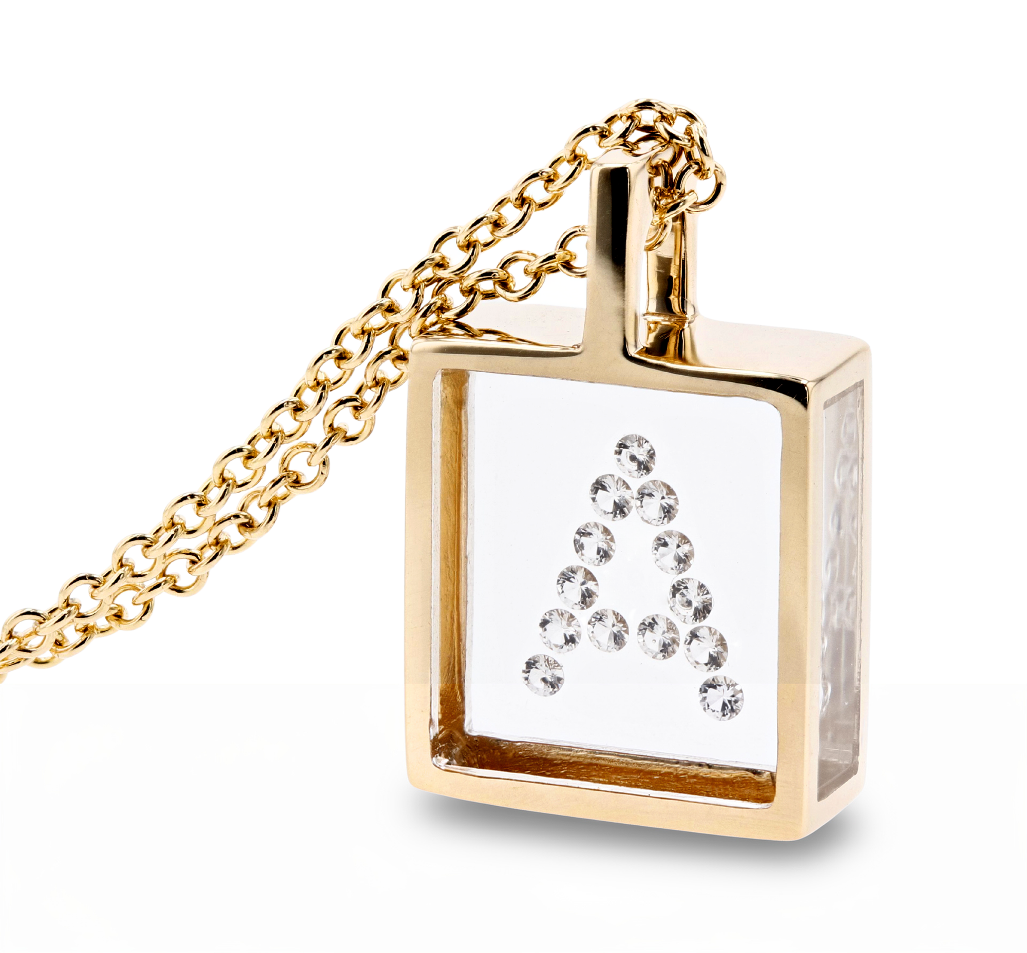 A gold square pendant necklace with a clear front panel set with diamonds  in a "A"  arrangement, hanging from a gold chain against a white background.