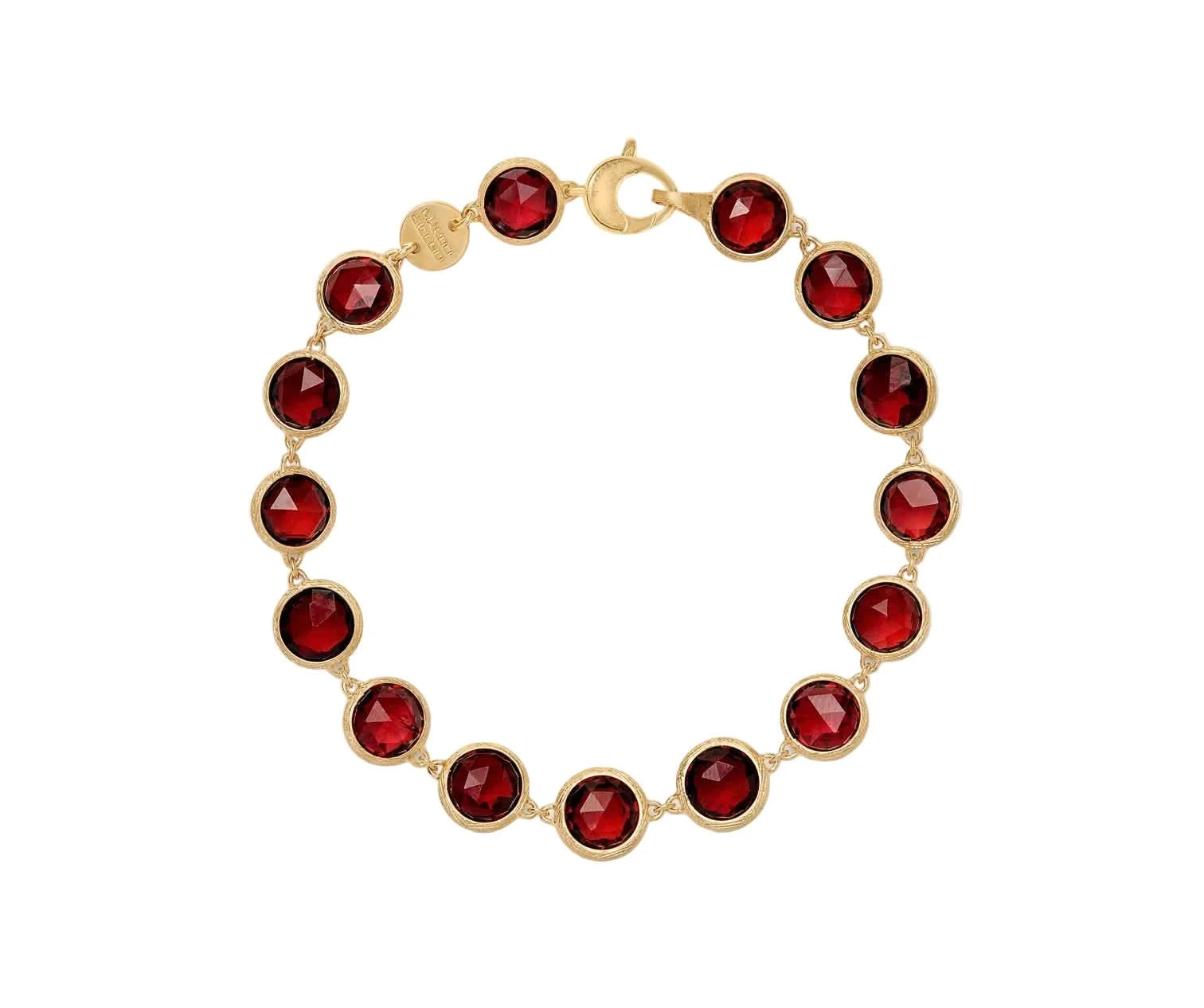 A gold link bracelet featuring ten faceted deep red gemstones in bezel settings, arranged in a circle on a light off-white background.