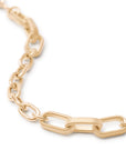 Gold chain necklace on a white background close up