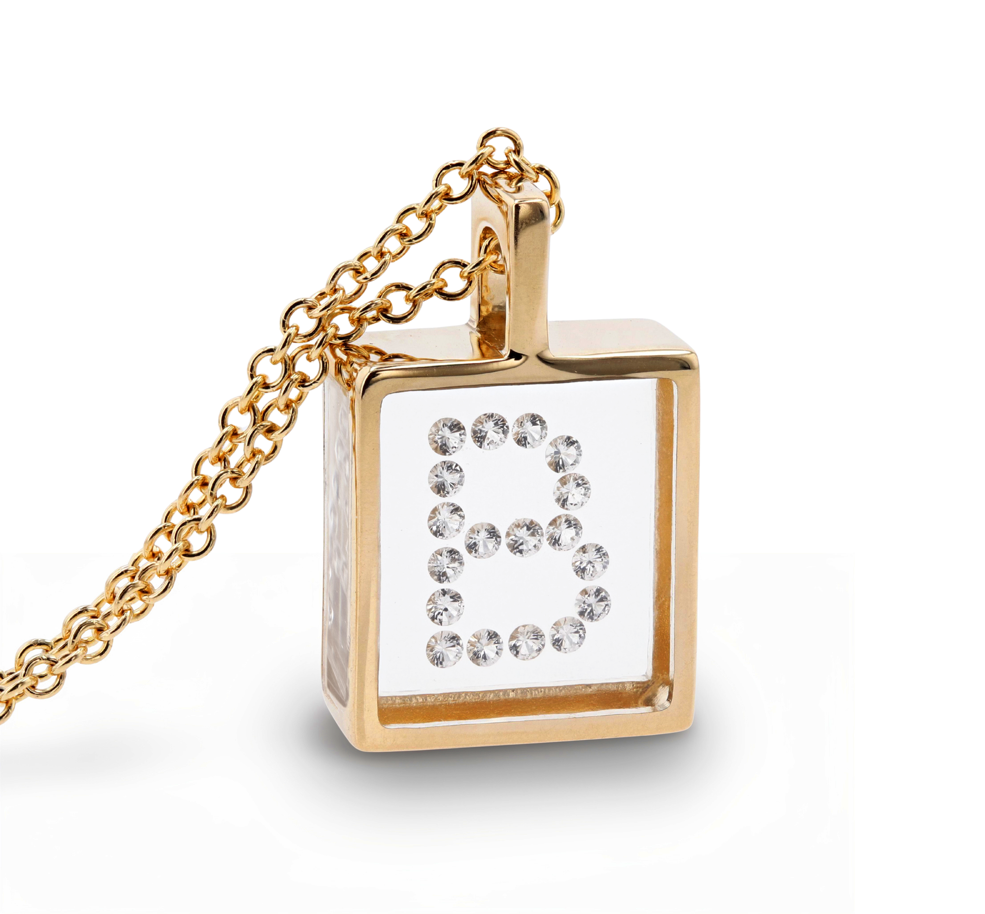 A gold pendant with a square pendant featuring a clear  diamond-enclosed letter 'B' on a white background, shown on a clean white studio background.