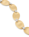 Gold necklace with oval links and embedded diamonds on a white background
