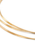 Three gold strands on a white background