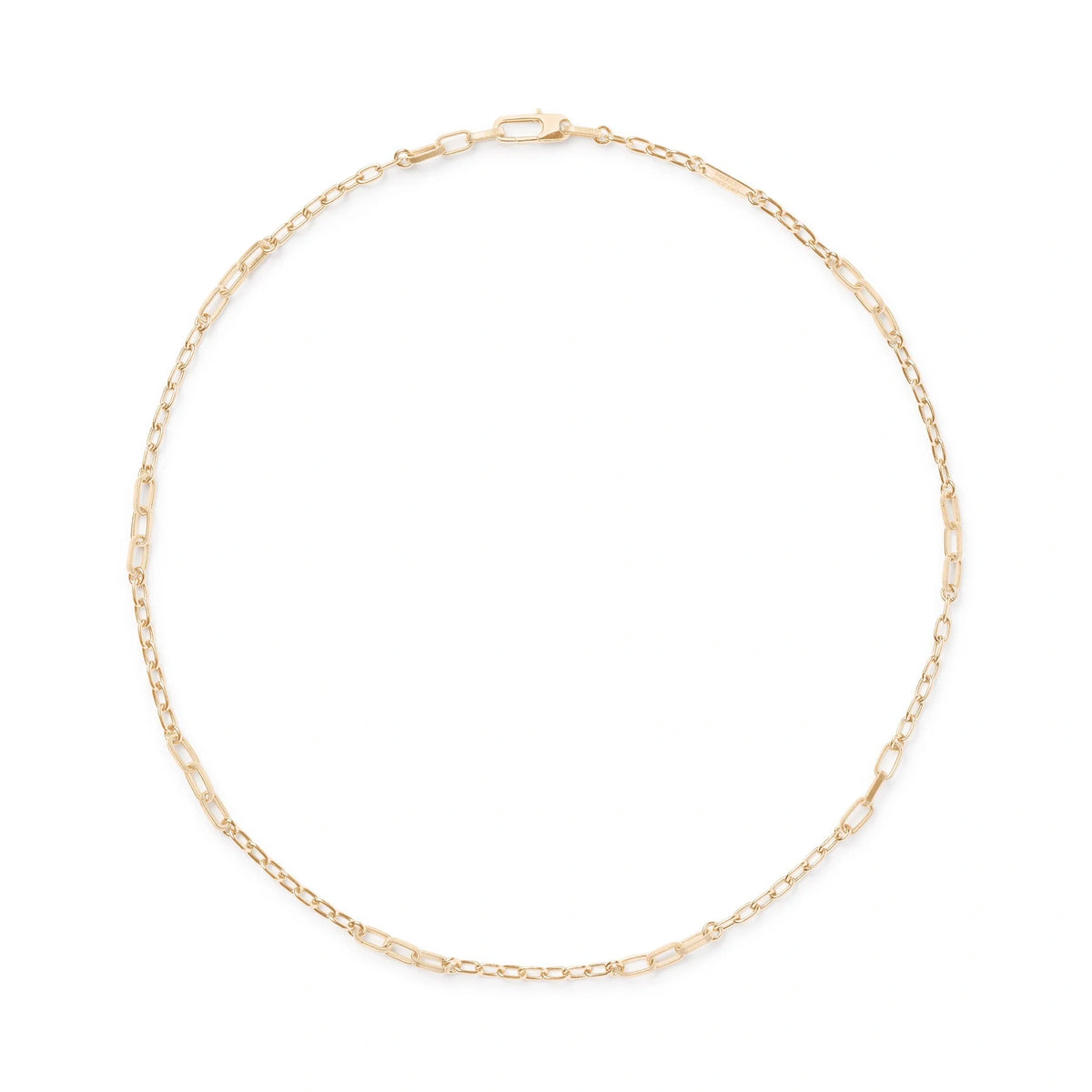 A delicate yellow gold chain necklace with elongated oval links, arranged in a circle on a clean white background.