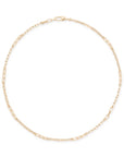 A delicate yellow gold chain necklace with elongated oval links, arranged in a circle on a clean white background.