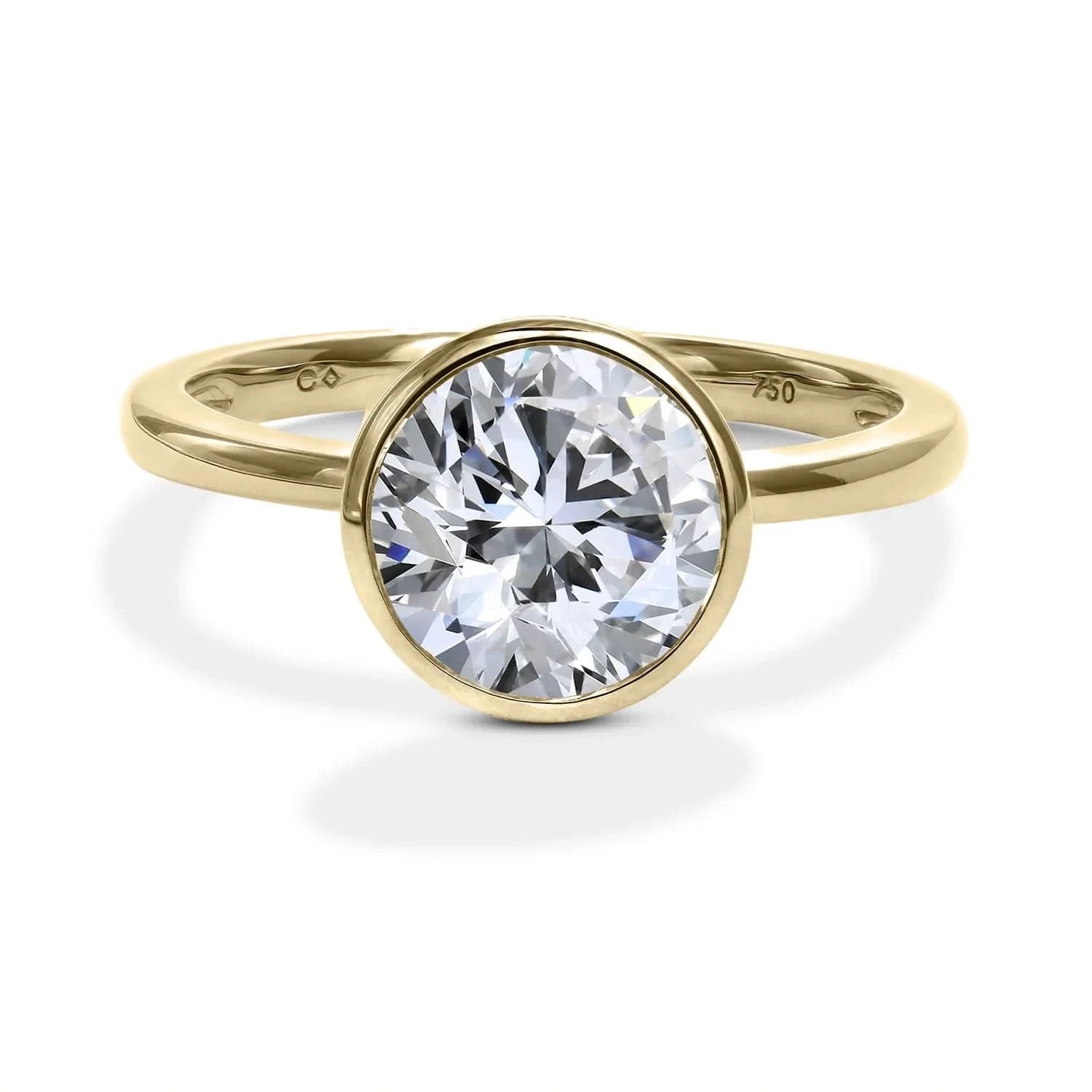 Head on shot of a yellow gold solitaire engagement ring with a bezel set brilliant round diamond from Clarity Diamonds