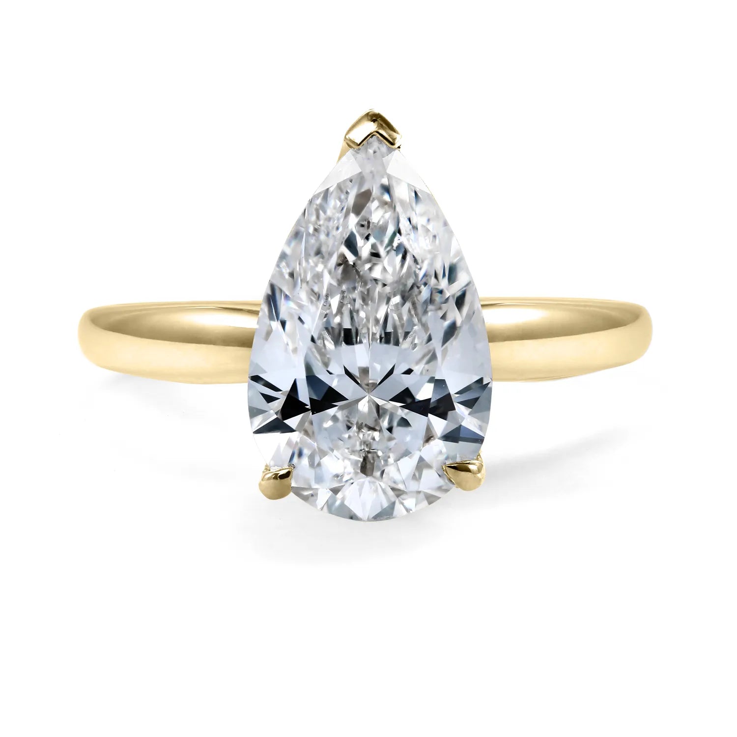Gold ring with a pear-shaped LAB GROWN diamond on a white background