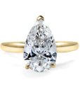 Gold ring with a pear-shaped LAB GROWN diamond on a white background