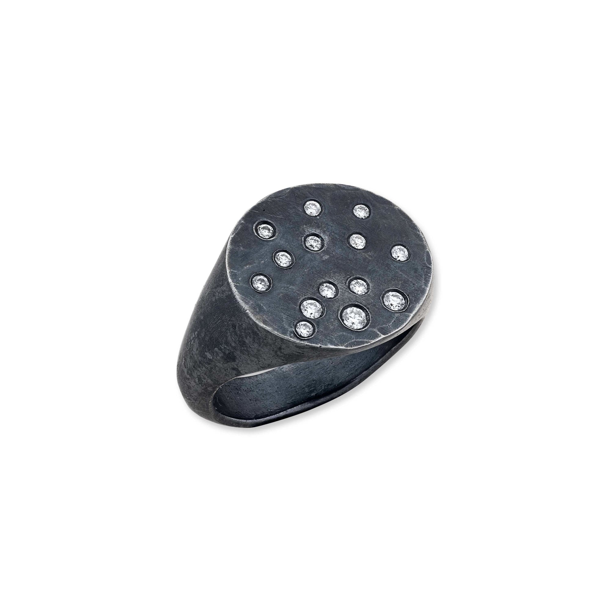 black Silver ring with small diamonds on a light gray background