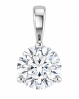 A round brilliant-cut diamond pendant in a three-prong silver setting on a solid white background.
