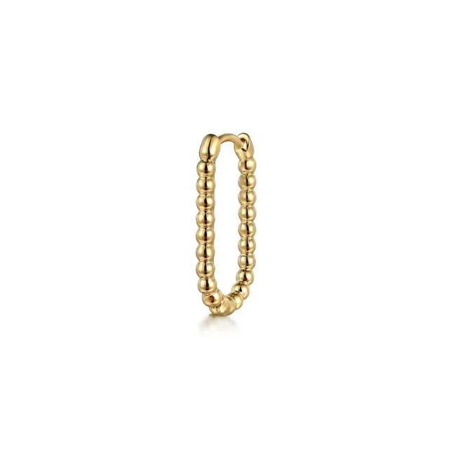 Gold earring with beaded design on a white background