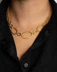 Close up of person wearing gold circular  chain necklace