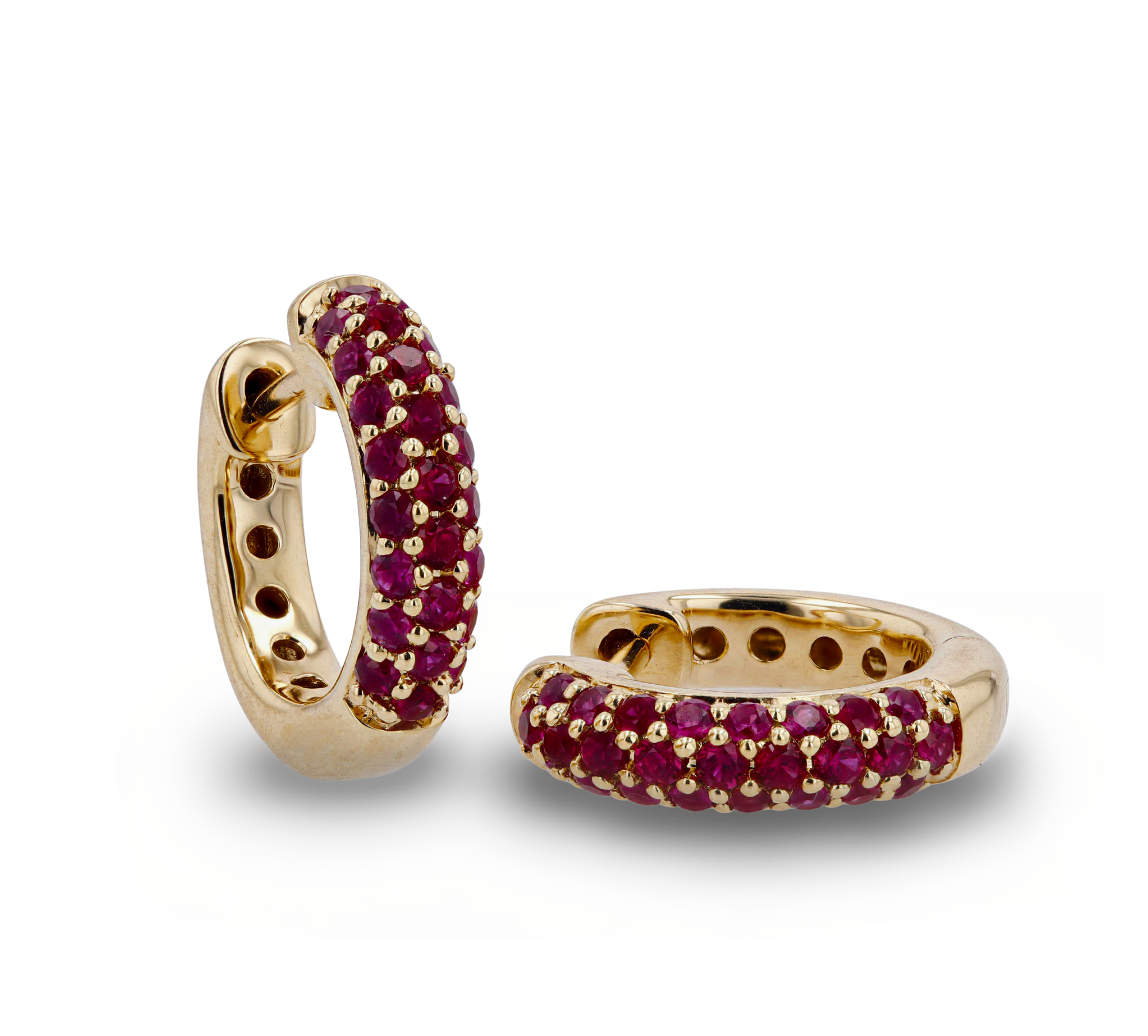 Gold hoop earrings with red gemstones on a white background