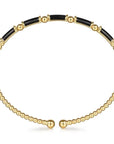 Gold and black beaded necklace on a white background side view