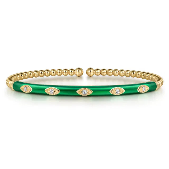 Gold and green bracelet with eye designs on a white background