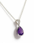 A white gold teardrop pendant necklace featuring a faceted purple gemstone, displayed slightly angled on a clean white background.