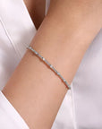 white  bracelet on a person's wrist with a white background
