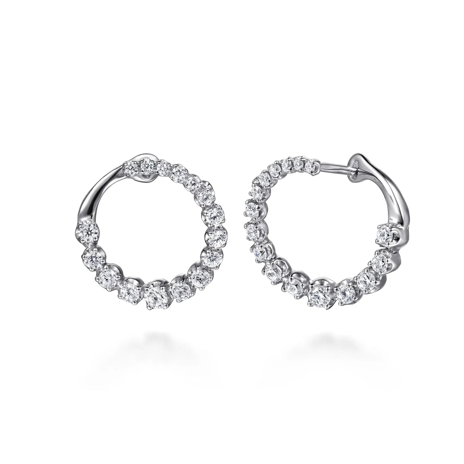 A pair of Gabriel &amp; Co. 14k white gold bypass hoop earrings (Reference EG15558W45JJ) showcasing a fluid, overlapping ribbon design set with a shimmering rows of small round brilliant diamonds, displayed against a clean white background