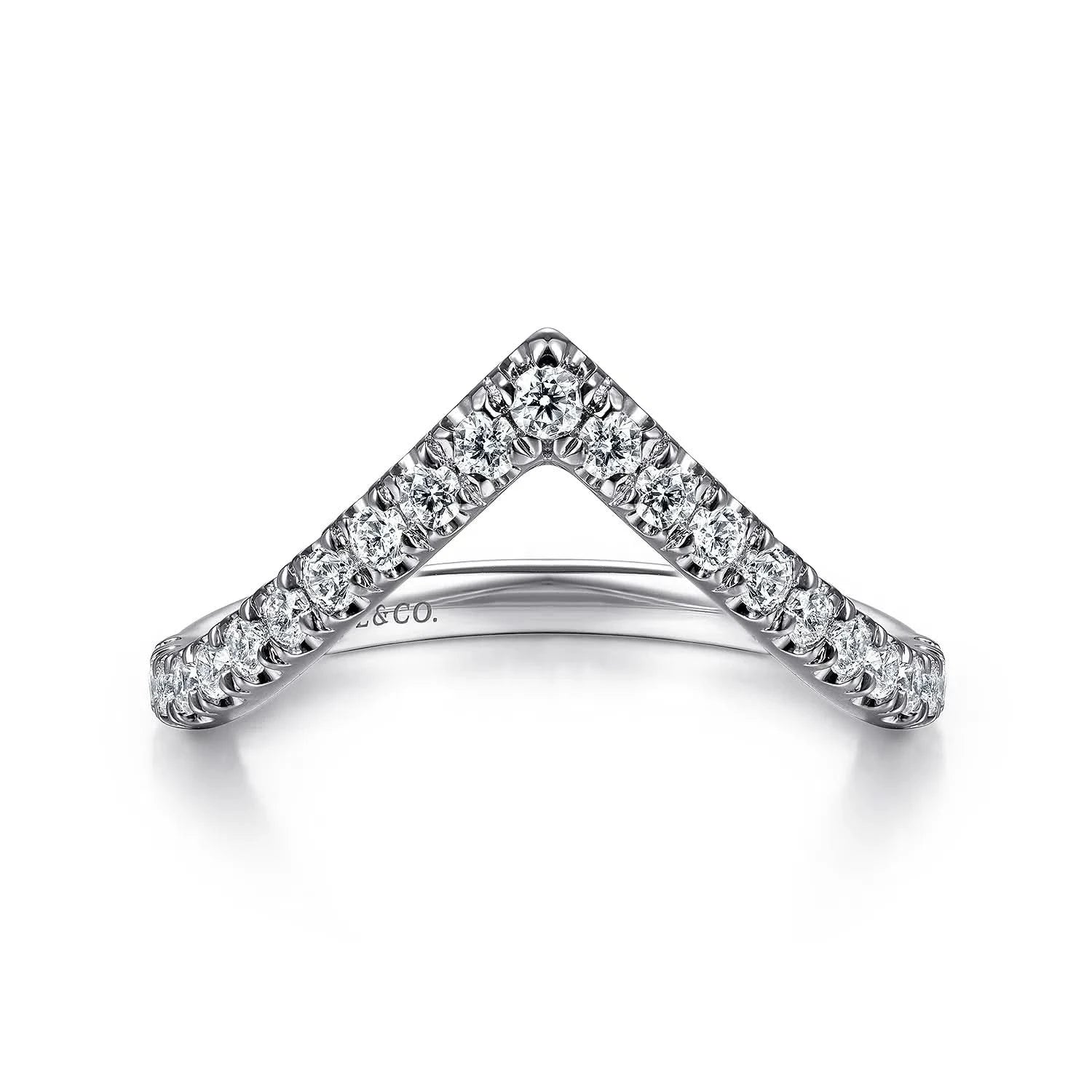 A Gabriel & Co. V-curved anniversary band, showcasing a sharp chevron line of round brilliant-cut diamonds set in high-polish 14k white gold, sculpted to fit around low-profile engagement ring center stones.