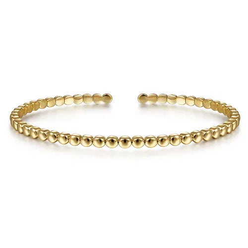 Gold beaded bracelet on a white background