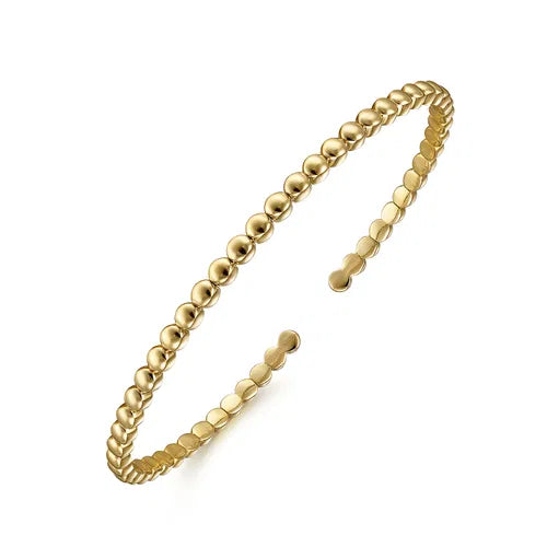 Gold bracelet on a white background angled