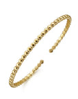 Gold bracelet on a white background angled