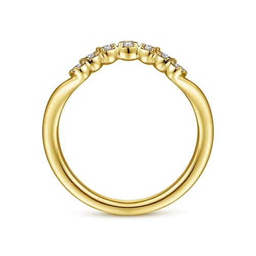 Close-up profile view of the Gabriel & Co. AN15556Y44JJ curved gold band, illustrating how the contoured wave nests perfectly against a classic engagement ring setting.