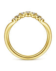 Close-up profile view of the Gabriel & Co. AN15556Y44JJ curved gold band, illustrating how the contoured wave nests perfectly against a classic engagement ring setting.