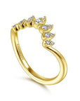 Gold ring with diamond accents on a white background angled view