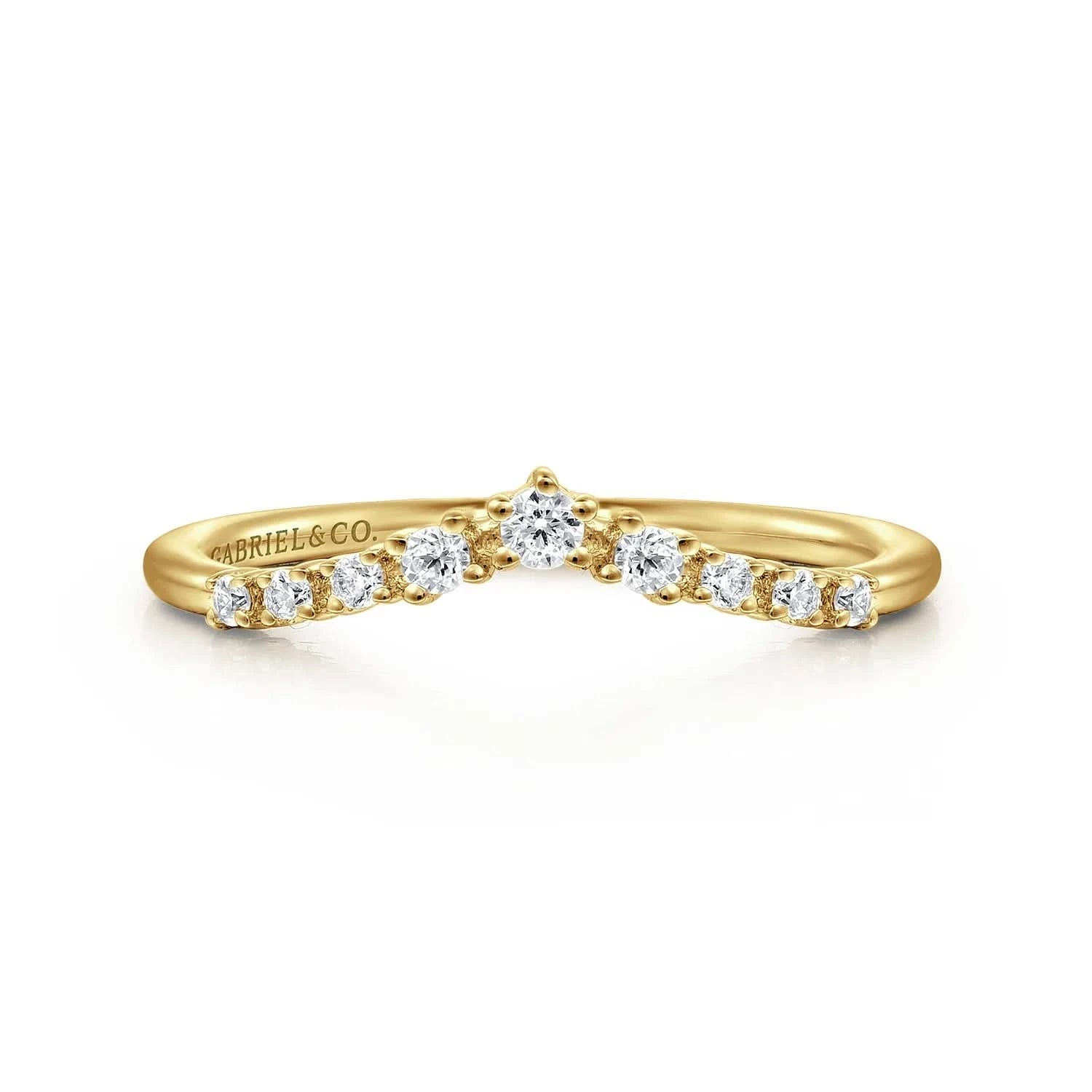 A Gabriel & Co. Devotion curved anniversary band, showcasing a contoured line of 0.15 carats of round prong-set diamonds in high-polish 14k yellow gold, designed to sit flush against an engagement ring.