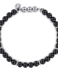 Black beaded bracelet with silver accents on a white background 6mm