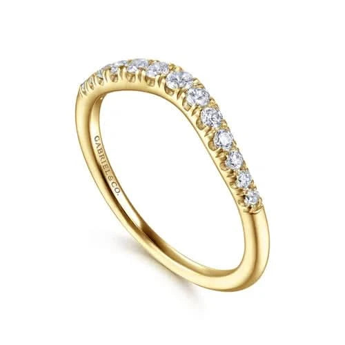angled view of curved anniversary band, showcasing a contoured line of round brilliant-cut diamonds set in high-polish 14k yellow gold, sculpted to fit flush against an engagement ring.