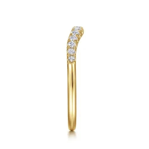 Side view of A Gabriel & Co. curved anniversary band, in high-polish 14k yellow gold, sculpted to fit flush against an engagement ring.