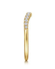Side view of A Gabriel & Co. curved anniversary band, in high-polish 14k yellow gold, sculpted to fit flush against an engagement ring.