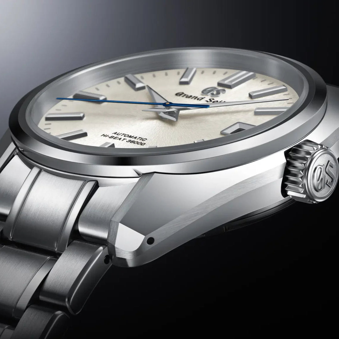 Silver wristwatch with a detailed face on a dark background