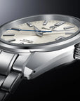 Silver wristwatch with a detailed face on a dark background