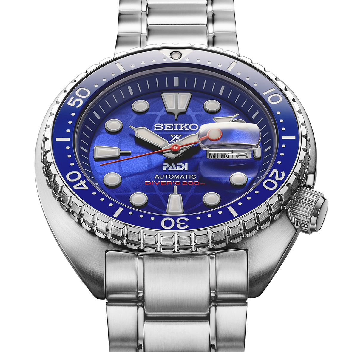 Seiko watch with blue dial and silver metal bracelet on a white background CLOSE UP ANGLED