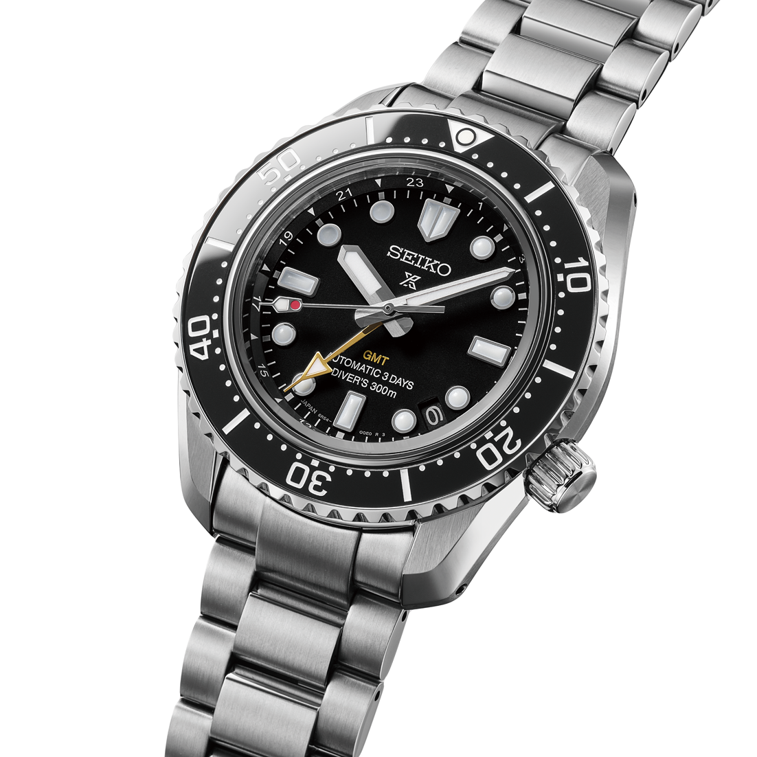 Close-up of Seiko watch with black dial and silver metal bracelet angled on a white background