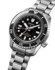 Close-up of Seiko watch with black dial and silver metal bracelet angled on a white background