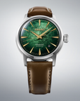 Seiko watch with green face and brown leather strap on gray background