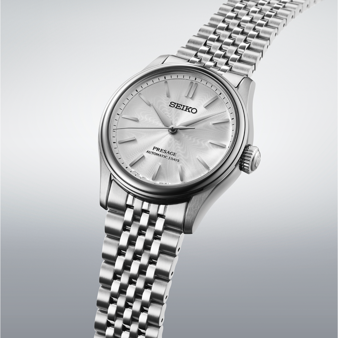 Silver Seiko watch with a detailed face on a light gray background