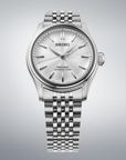 Silver Seiko watch on a gray background facing