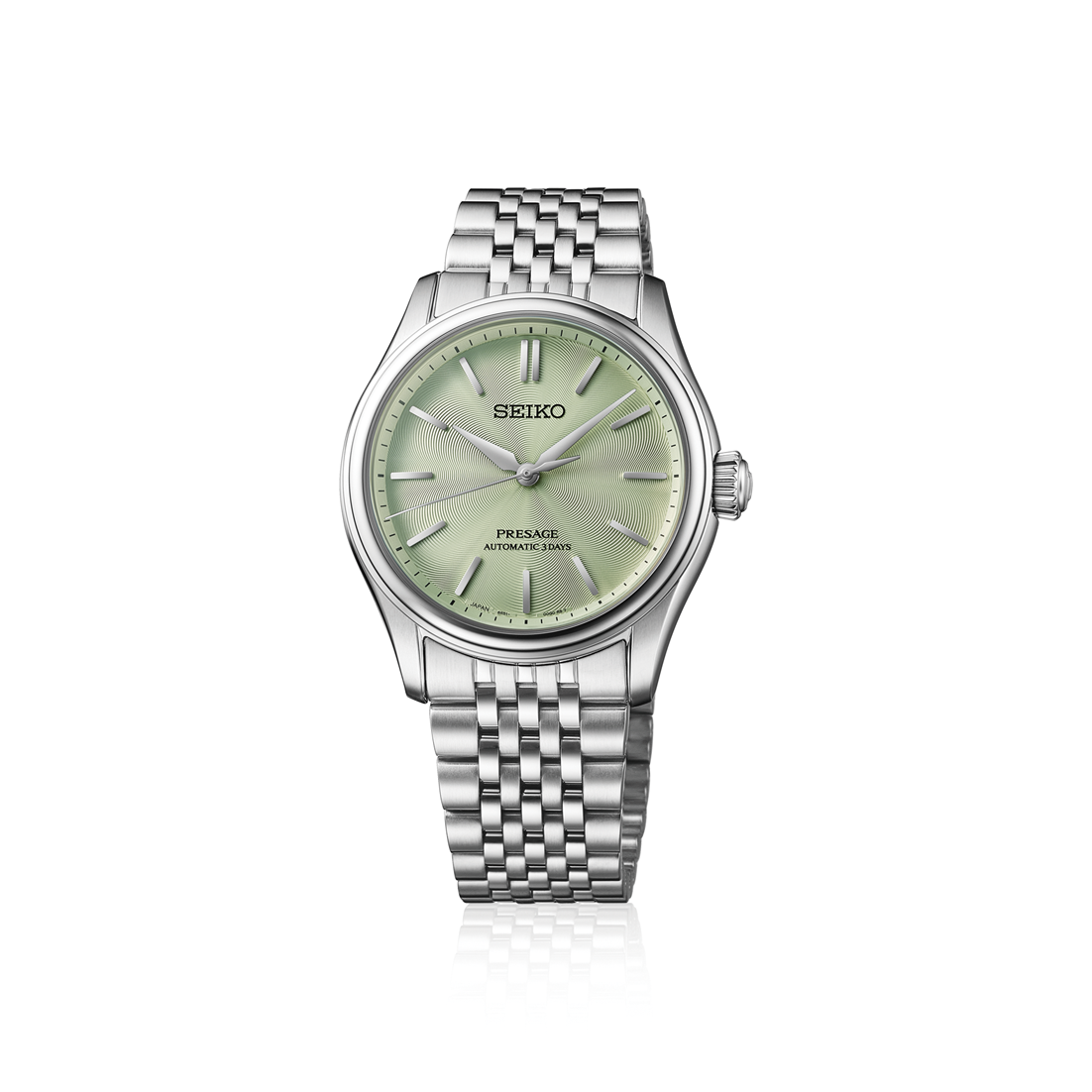 Seiko watch with silver bracelet and green dial on a white background